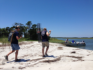 DNR staff return to boat after protecting nests on a remote beach