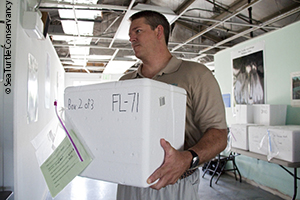 David Gofrey of partner STC carries rescued eggs into NASA