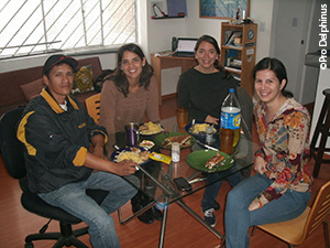 Pro Delphinus staff share a meal with Pedro, a fisherman, in the Pro Delphinus office