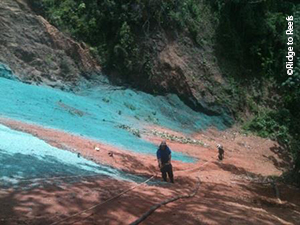 Slopes are sprayed with hydroseed mixture to stabilize soil and provide for rapid vegetative stabilization