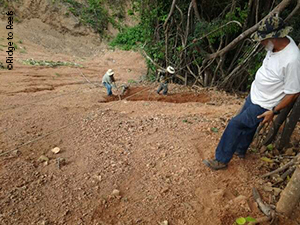 Local partners and contractors prepare slope for stabilization/restoration